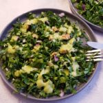 A picture of Kale Salad with some avocado dressing.