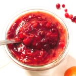 Cranberry Sauce with Apples and clementine served on a small bowl.s