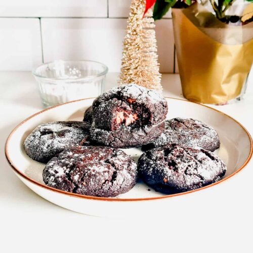A photo showing keto and gluten-free chocolate crinkle cookies on a plate.