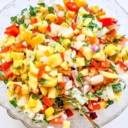 A picture of mango habanero salsa with pineapple in a bowl.