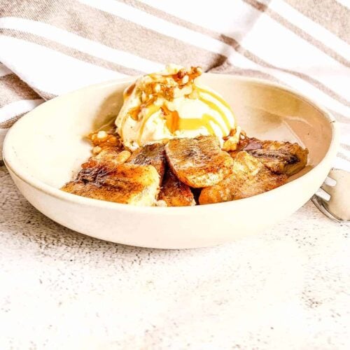 A small bowl of air-fried bananas served with a scoop of ice cream.