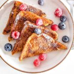A plate of German French Toast (Arme Ritter) served with berries.