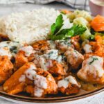 Air fryer salmon bites served on a plate with some rice.
