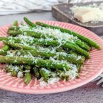 A plate of air fryer garlic green beans with Parmesan cheese.