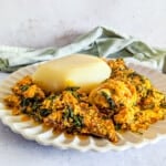 A plate of egusi soup with fufu.