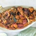 Greek lamb (Kleftiko) with potatoes served on a tray.