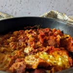 Menemen with sucuk in a skillet.