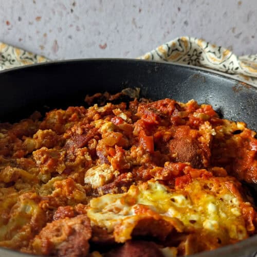 Menemen with sucuk in a skillet.