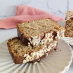 Sliced oatmeal banana bread on a plate.