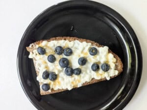 Toast topped with cottage cheese, blueberries, and honey ready for air frying.