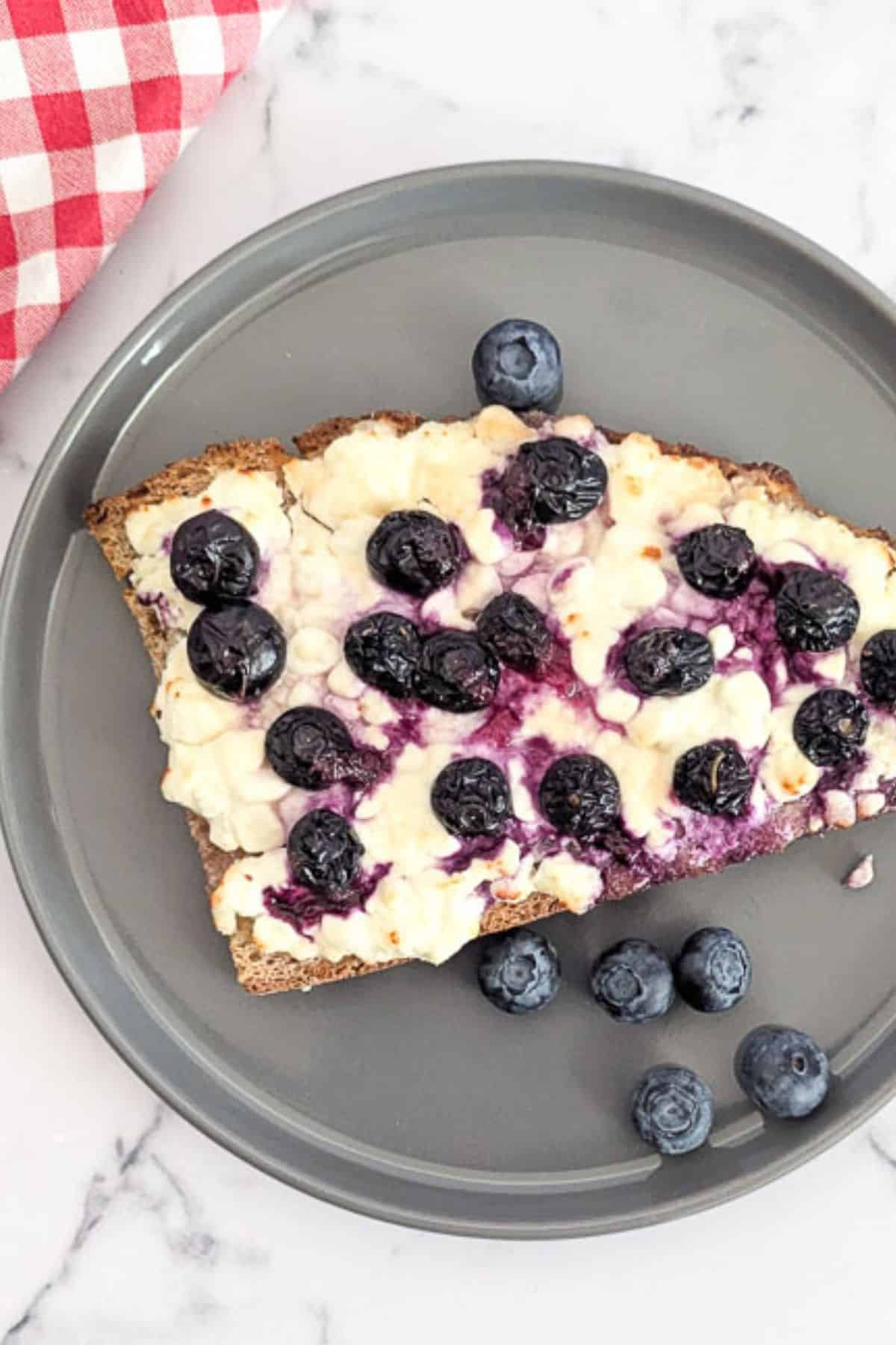 Air fried toast topped with cottage cheese, blueberries, and honey.