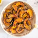 Top-down picture of air fryer acorn squash slices served in a bowl.