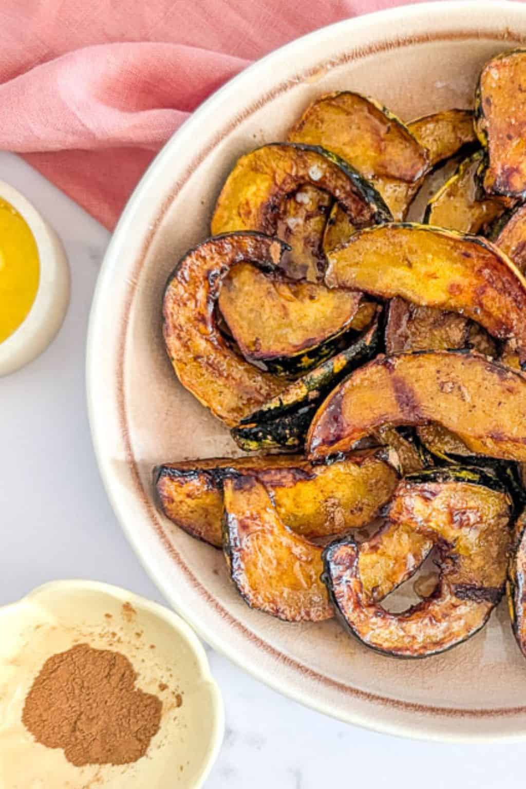 Air fried acorn maple squash slices with butter and cinnamon served on the side.