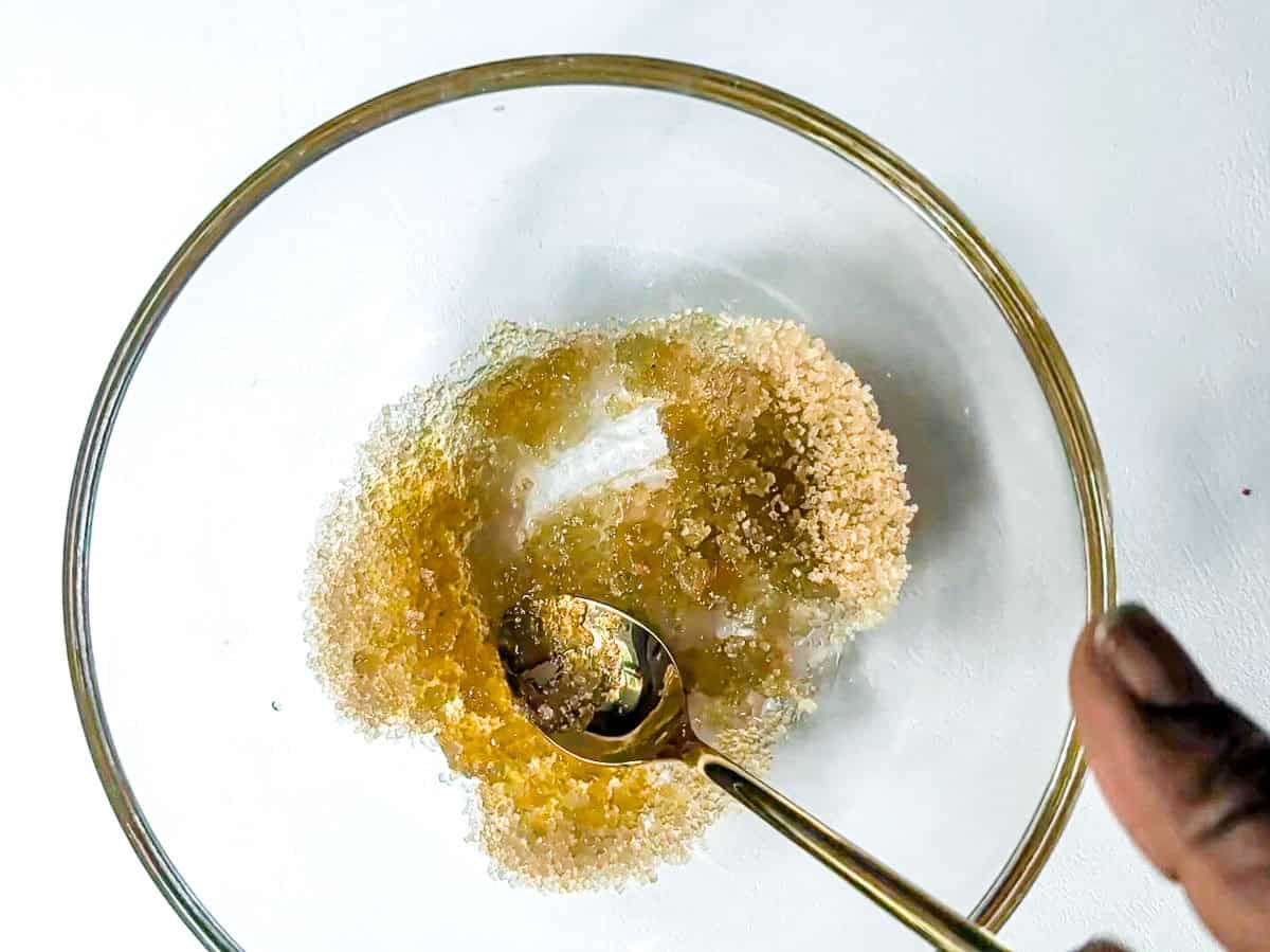 Combining brown sugar and oil in a bowl.