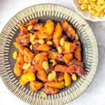Spicy fried plantain (kelewele) on a plate served with peanuts.