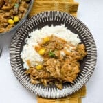 Yassa chicken served with some rice.