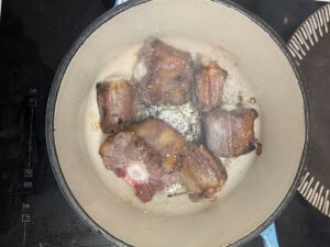 Oxtail browning in a pot.