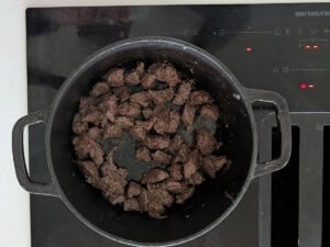 Cubed beef browning in a pot.