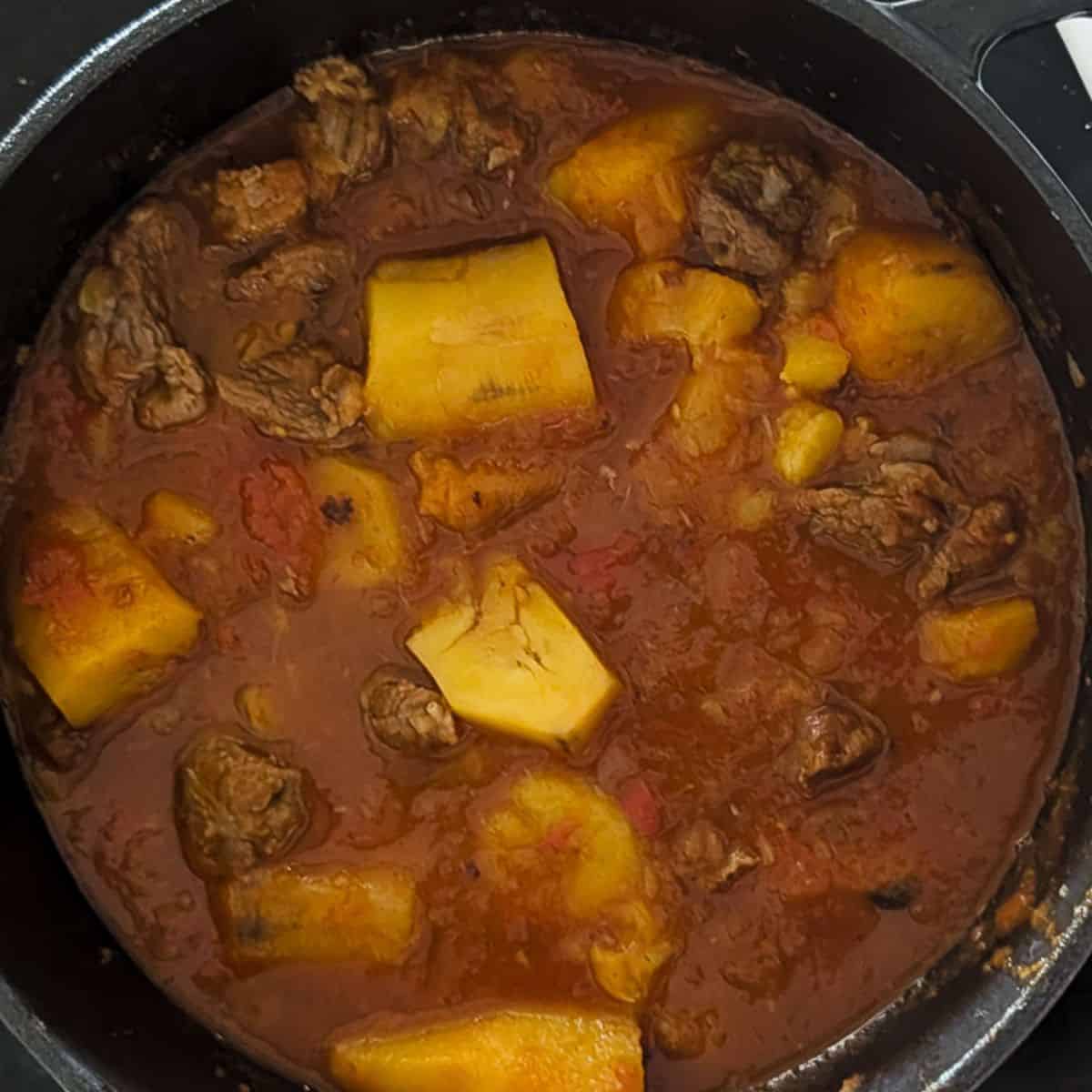 Cooked matoke stew with beef, ready for garnishing and serving.